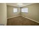 Cozy bedroom featuring plush carpeting, neutral walls, and two windows allowing natural light at 2896 Hogan Rd, East Point, GA 30344