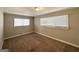 Cozy bedroom with neutral walls, plush carpeting, and two windows providing plenty of natural light at 2896 Hogan Rd, East Point, GA 30344