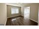 Bright dining area featuring elegant wood-look floors and a large window offering ample natural light at 2896 Hogan Rd, East Point, GA 30344