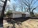 Inviting single-story home with neutral exterior, landscaped front yard, and mature trees around the property at 2896 Hogan Rd, East Point, GA 30344