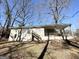 Ranch-style home exterior with stairs leading to a covered porch in the backyard at 2896 Hogan Rd, East Point, GA 30344