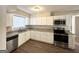 Well-lit kitchen with modern stainless steel appliances, granite countertops, and ample white cabinetry at 2896 Hogan Rd, East Point, GA 30344