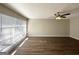 Spacious living room with wood-look flooring, ceiling fan, and a large window for plenty of sunlight at 2896 Hogan Rd, East Point, GA 30344