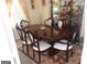 Dining room featuring a dark wood table with six chairs and a decorative china cabinet at 4032 Ward Lake Trl, Ellenwood, GA 30294