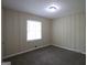 Cozy bedroom with a neutral color scheme, and wall paneling at 2364 Farley St, East Point, GA 30344
