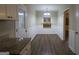Bright dining area with modern light fixture, white wainscoting and hardwood floors at 2364 Farley St, East Point, GA 30344
