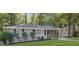 Charming single-story home featuring a well-manicured lawn and mature trees at 2364 Farley St, East Point, GA 30344