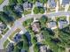 Aerial view of a residential neighborhood with tree-lined streets and well-maintained homes at 2810 Promenade Pl, Buford, GA 30519
