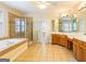 Large bathroom with double vanity, tiled floors, a soaking tub, and a shower stall at 2810 Promenade Pl, Buford, GA 30519