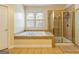 Bathroom featuring a soaking tub, a tiled shower, and a neutral color scheme at 2810 Promenade Pl, Buford, GA 30519