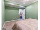 Green bedroom with carpet, view to stairwell, ceiling fan, and closet at 2810 Promenade Pl, Buford, GA 30519