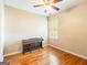 Cozy bedroom with hardwood floors, a ceiling fan, a window, and a piano for creative inspiration at 2810 Promenade Pl, Buford, GA 30519
