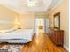 Bedroom features hardwood floors, and a view to the bath area and dresser at 2810 Promenade Pl, Buford, GA 30519