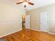 Spacious bedroom with hardwood floors, neutral walls, and white trim, offering a blank canvas for personalization at 2810 Promenade Pl, Buford, GA 30519