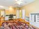 Bright bonus room with hardwood floors, a desk area, a ceiling fan, and built-in storage solutions at 2810 Promenade Pl, Buford, GA 30519