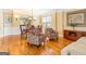 Open-concept dining area with hardwood floors, natural light, and decorative chairs at 2810 Promenade Pl, Buford, GA 30519