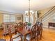 Elegant dining room with hardwood floors, staircase, and ample natural light at 2810 Promenade Pl, Buford, GA 30519