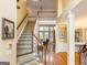 Welcoming entryway with staircase featuring carpeted treads and an open view of the home at 2810 Promenade Pl, Buford, GA 30519