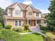 Charming home featuring stone accents, a welcoming front porch, and lush landscaping at 2810 Promenade Pl, Buford, GA 30519