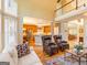Open concept living room offers views of the kitchen and has hardwood floors and plenty of natural light at 2810 Promenade Pl, Buford, GA 30519