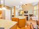 View from kitchen shows the living room with high ceilings, a fireplace, and plenty of natural light at 2810 Promenade Pl, Buford, GA 30519