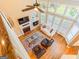 High-angle view of the bright living room with fireplace, large windows, and hardwood floors at 2810 Promenade Pl, Buford, GA 30519