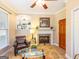 Cozy living room featuring a fireplace, built-in shelving, a comfortable chair, and natural light at 2810 Promenade Pl, Buford, GA 30519