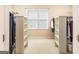 Spacious walk-in closet with built-in shelving and rods for ample storage, illuminated by a bright window at 2810 Promenade Pl, Buford, GA 30519
