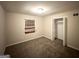 Cozy bedroom features neutral walls, new carpeting, and a window at 4390 Mercer Rd, Decatur, GA 30035