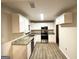 Modern kitchen with stainless steel appliances, granite countertops, and white cabinetry at 4390 Mercer Rd, Decatur, GA 30035