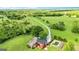 Beautiful home with a well-manicured lawn, mature trees, long driveway, and a refreshing pool, as seen from above at 68 Riveree Rd, Brooks, GA 30205