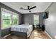 Bedroom with two windows, ceiling fan, and attached desk at 68 Riveree Rd, Brooks, GA 30205