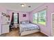 Bedroom boasts 2 large windows, ceiling fan, neutral colored walls and carpeted floor at 68 Riveree Rd, Brooks, GA 30205