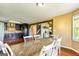 Eat-in kitchen view showcases hardwood floors, a rustic table and white chairs, and a view to the living room at 68 Riveree Rd, Brooks, GA 30205