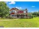 Attractive two-story home featuring a inviting front porch and a well-maintained green lawn at 68 Riveree Rd, Brooks, GA 30205