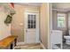 Welcoming hallway with built-in bench and storage, leading to a brightly lit bathroom at 68 Riveree Rd, Brooks, GA 30205