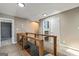 Second-floor hallway view shows wooden railing and access to various rooms at 68 Riveree Rd, Brooks, GA 30205