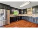 Well-equipped kitchen with stainless steel appliances, dark cabinetry and backsplash, and light countertops at 68 Riveree Rd, Brooks, GA 30205