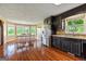 Open kitchen boasts stainless appliances, black cabinets, hardwood floors, and eat-in breakfast nook at 68 Riveree Rd, Brooks, GA 30205