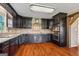 Open kitchen featuring stainless steel appliances, dark cabinetry and backsplash, and light countertops at 68 Riveree Rd, Brooks, GA 30205