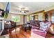 Bright living room with hardwood floors, featuring comfortable seating arrangements and natural light from large windows at 68 Riveree Rd, Brooks, GA 30205