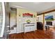 Spacious living room showcasing hardwood floors, a decorative accent wall, and a cozy fireplace at 68 Riveree Rd, Brooks, GA 30205