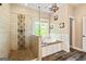 Stylish main bathroom with a glass shower and separate soaking tub complemented by wood-look tile flooring at 68 Riveree Rd, Brooks, GA 30205