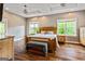 Spacious main bedroom featuring hardwood floors, a wooden bed frame, and neutral wall colors at 68 Riveree Rd, Brooks, GA 30205