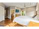 Main bedroom featuring an ensuite bathroom, a balcony, a TV, and a wooden bed frame at 68 Riveree Rd, Brooks, GA 30205