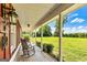 Inviting front porch with rocking chairs, providing a scenic view of the lush green lawn at 68 Riveree Rd, Brooks, GA 30205