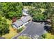 Sprawling property aerial showcasing lush greenery, a detached garage and ample parking with a serene setting at 441 Crumbley Rd, Mcdonough, GA 30252