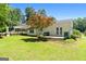 Well-maintained backyard with a spacious lawn, mature trees, a deck and a peaceful atmosphere at 441 Crumbley Rd, Mcdonough, GA 30252