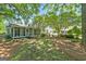 Lush backyard showcasing a white home with screened in porch and mature trees at 441 Crumbley Rd, Mcdonough, GA 30252