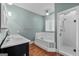 Bathroom with tub, walk-in shower and double vanity, complete with wood floors at 441 Crumbley Rd, Mcdonough, GA 30252